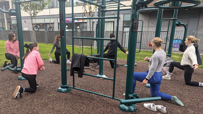 Group calisthenics classes and workouts in Dublin, Ireland, featuring participants training with bodyweight exercises outdoors