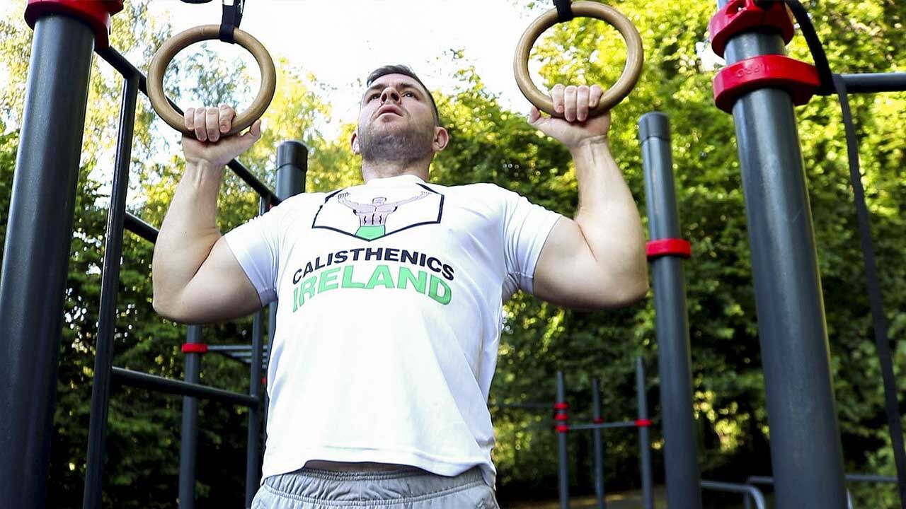 Calisthenics Ireland coach performing strict pull-ups for CrossFit strength