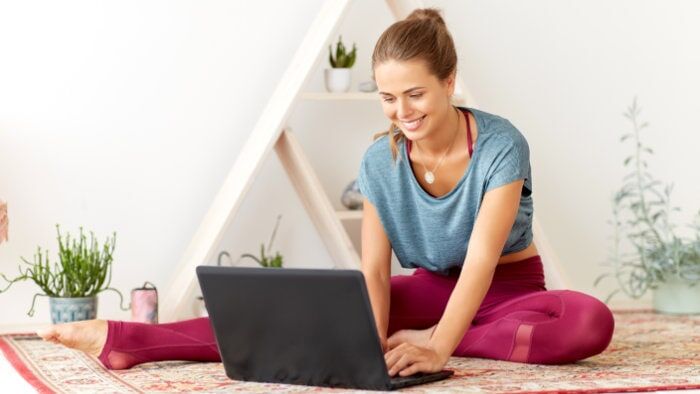 Woman on a video call with her coach, receiving personalised online training guidance from Calisthenics Ireland