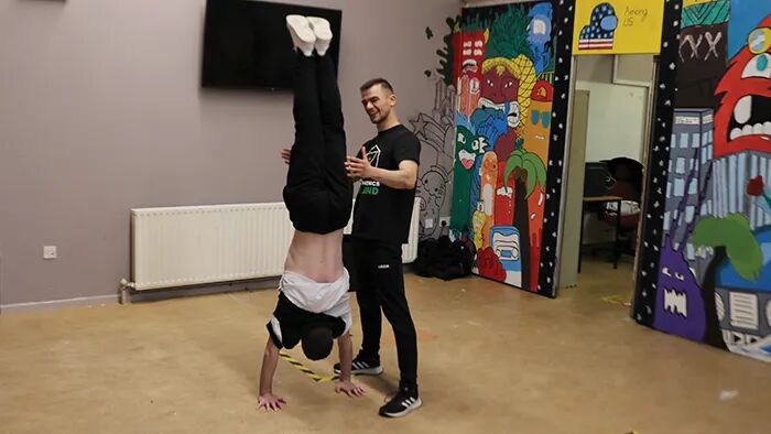 One-on-one calisthenics personal training session, focused on bodyweight strength and technique development