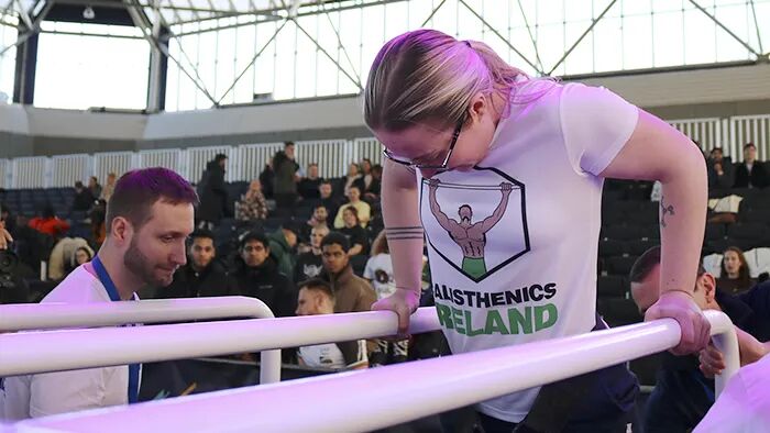 Group calisthenics workshop in progress, with participants learning bodyweight training techniques during a Calisthenics Ireland event
