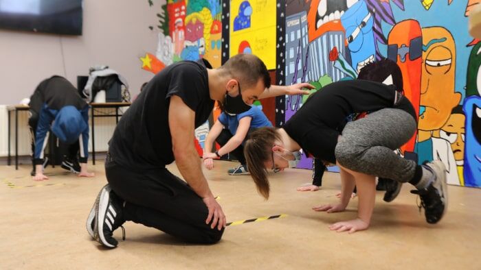 Students taking part in a Calisthenics Ireland workshop for secondary schools, learning bodyweight exercises in a guided group setting