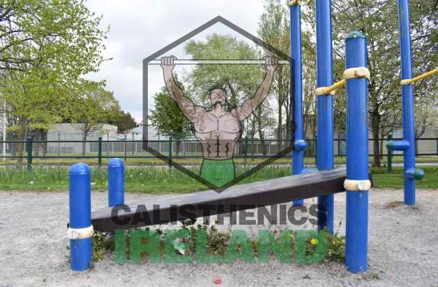 Outdoor calisthenics training area at Gaels Drumfinn Park in Ballyfermot, featuring equipment for pull-ups, dips, and full-body workouts