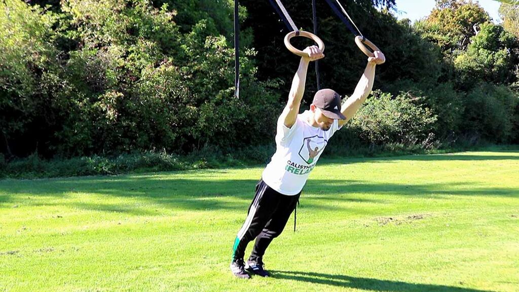 Calisthenics Ireland coach performing controlled ring strength exercise to support muscle retention during fat loss