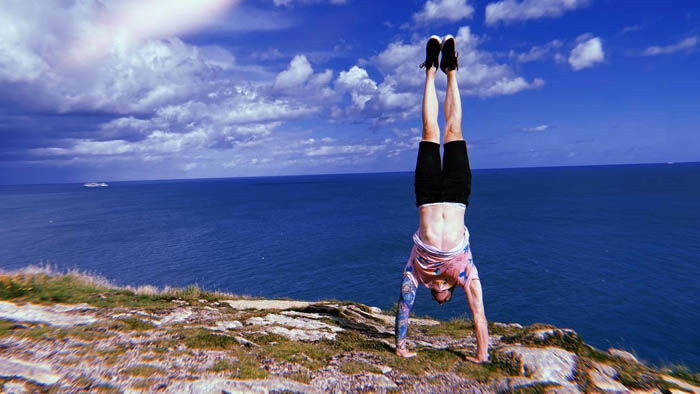 Calisthenics Ireland student demonstrating a strong handstand at Howth while overlooking the Irish coastline