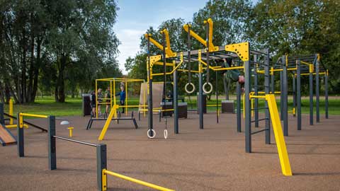 Outdoor calisthenics equipment setup in Ireland featuring pull-up bars and parallel bars in a public park